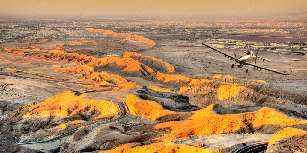 IOMAX's AT-802 Border Patrol Aircraft in flight over desert