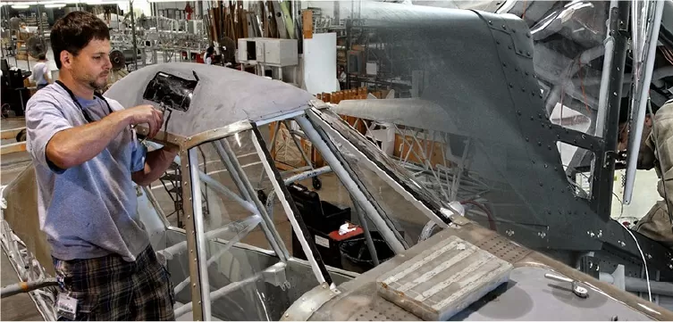 IOMAX engineer performing aircraft maintenance in hangar 